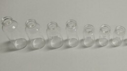 Multiple vials in a line from big to smalll